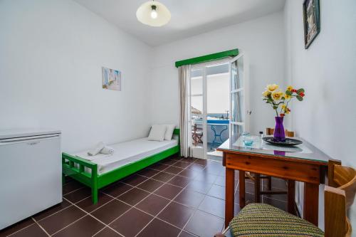 a living room with a couch and a table at Ancient Thera Apartments in Kamari