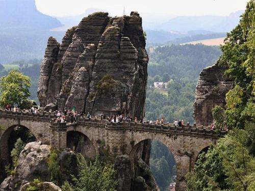 a group of people on a bridge on a mountain at Penzion Oáza Hřensko in Hřensko