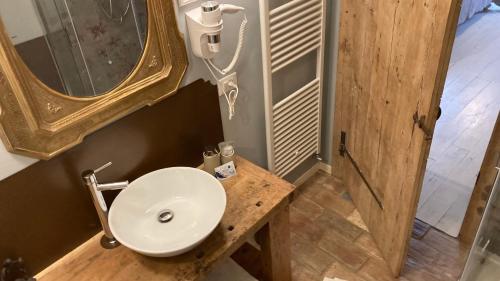 a bathroom with a sink and a mirror at B&B Antique Maison in Soave