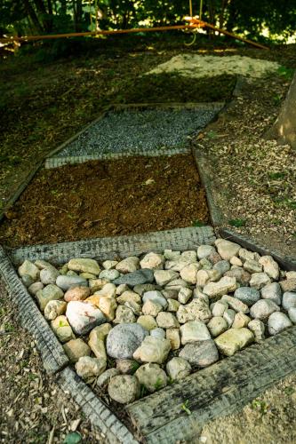 a rock garden with rocks on the ground at Baltās anemones in Jumprava