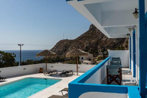 a view from the balcony of a villa with a swimming pool at Ancient Thera Apartments in Kamari