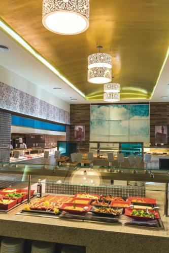 a buffet line with food in a restaurant at Riu Republica - Adults Only - All Inclusive in Punta Cana