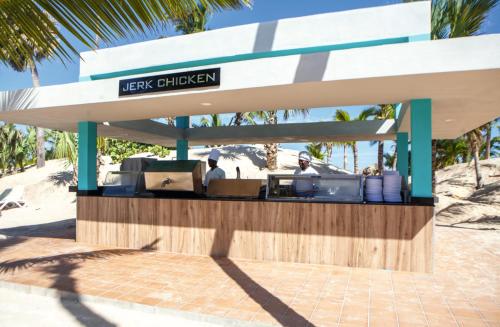 a kiosk at the beach with people ordering food at Riu Republica - Adults Only - All Inclusive in Punta Cana