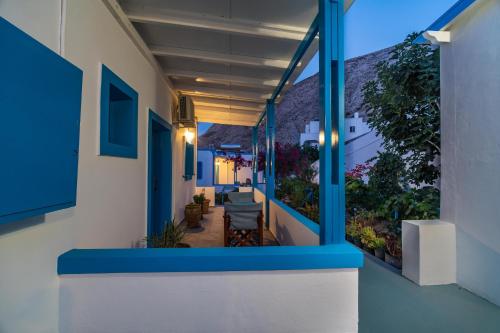 a balcony of a house with blue and white walls at Ancient Thera Apartments in Kamari