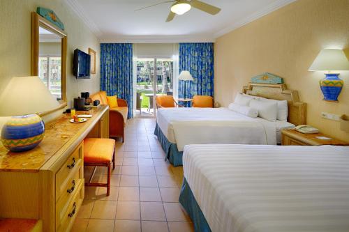 a hotel room with two beds and a desk at Barceló Maya Beach - All Inclusive in Xpu Ha