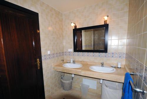 a bathroom with two sinks and a mirror at TRIPLEX LA MARINA SAIDIA in Saidia 
