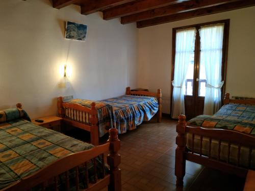 Una cama o camas en una habitación de Pension Casat