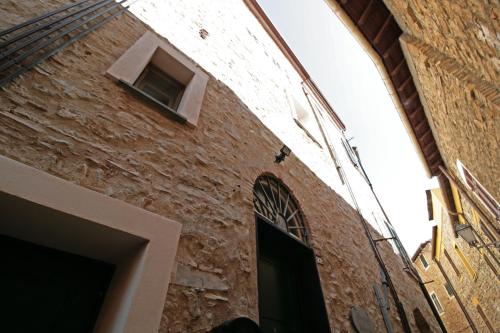 a brick building with a door and a window at Albachiara home - vista mare in Cipressa