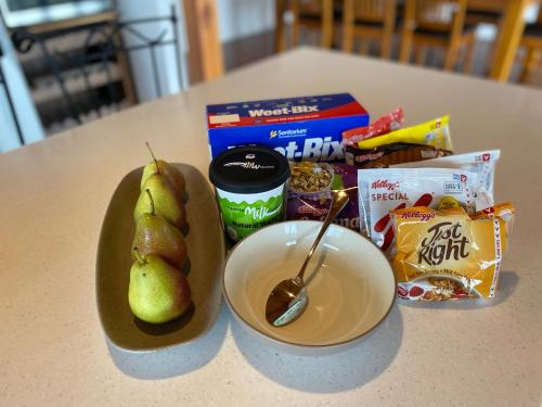 a table with a bowl of pears and a bowl of food at Old Coach Road Estate in Hindmarsh Valley