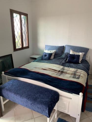 a bedroom with a bed with blue blankets and pillows at Erdei házak in Csopak