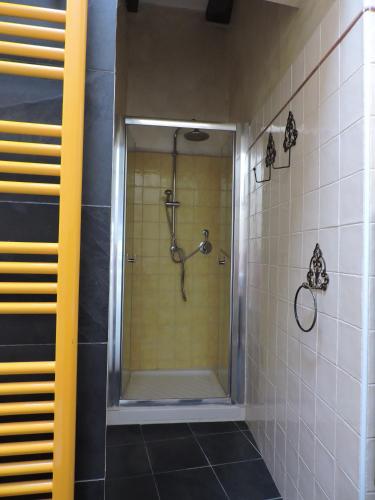 a bathroom with a shower with a glass door at Albachiara home - vista mare in Cipressa
