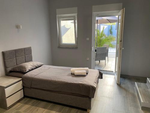 a bedroom with a bed and a door to a patio at Villa Maleo in Medulin