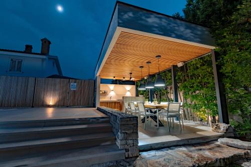 a patio with a table and chairs on a deck at Residence Peček in Novigrad Istria