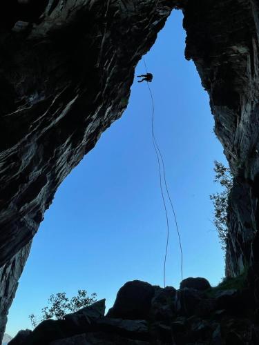 a helicopter flies through the sky in a cave at Sveggvika Guesthouse in Averoy