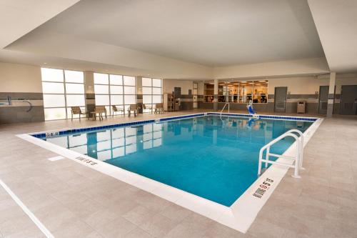 a large swimming pool with a person in the middle of it at Hyatt House Nashville Airport in Nashville