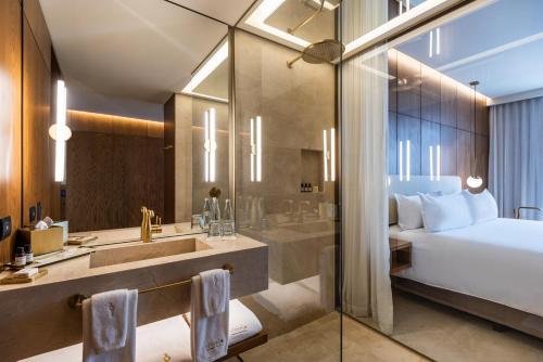 
a hotel room with two sinks and a large mirror at Elcielo Hotel & Restaurant in Medellín
