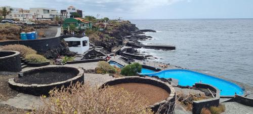 an aerial view of a swimming pool next to the water at Casa rural meridiano in El Pinar del Hierro