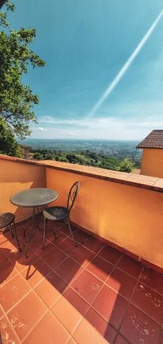 a table and chairs on a balcony with a view at Bellavista Hotel & Osteria in Lamporecchio