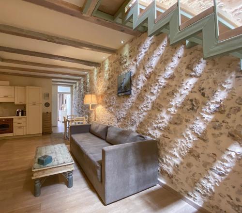 a living room with a couch in front of a wall at Casa Maistra Residence in Rethymno Town