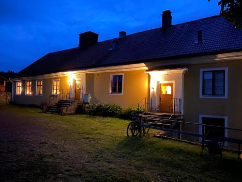 ein weißes Haus mit seitlicher Beleuchtung in der Unterkunft Eds Bruk Basecamp in Edsbruk