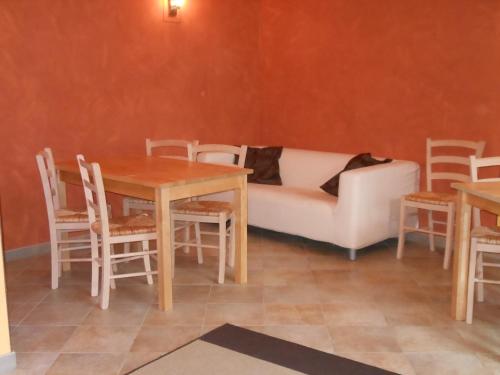 a living room with a couch and a table and chairs at Le Lasarde in Venasca