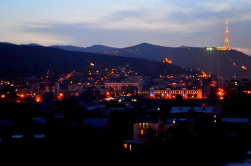 a view of a city at night at Hotel RichI G A in Tbilisi City