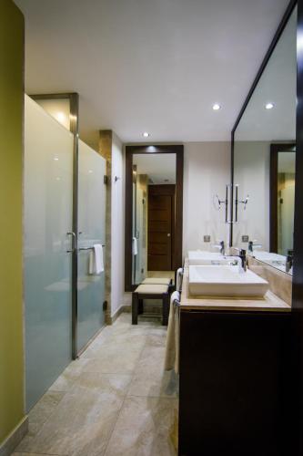 a bathroom with a large sink and a shower at Barceló Maya Caribe - All Inclusive in Xpu Ha