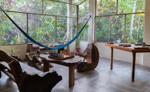 a room with a hammock and a table and chairs at Villas Ecotucan in Bacalar