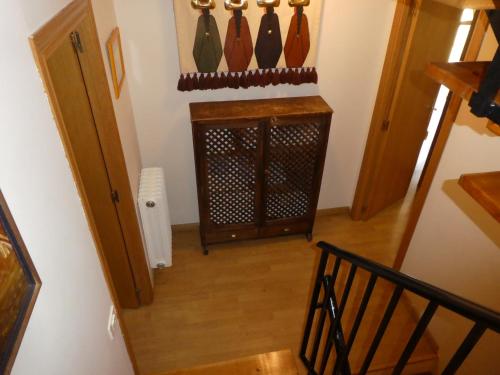 an attic room with a staircase with vases on the wall at Casa con jardín frente ciudadela in Jaca