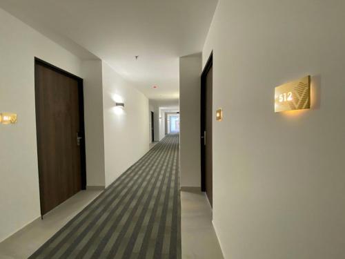 an empty hallway with a door and a sign on the wall at Wyndham Puebla Angelopolis in Puebla