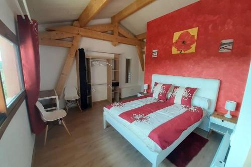 a bedroom with a bed and a red wall at Gite La Saubolle à Marciac in Marciac