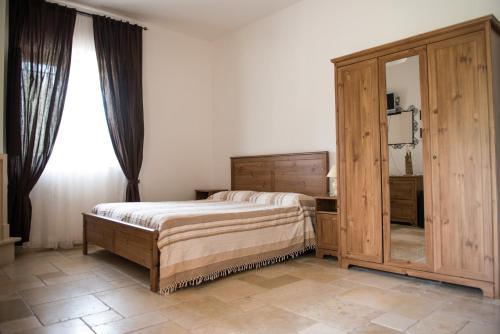 Un pat sau paturi într-o cameră la La Vigna Vecchia