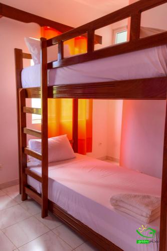 a bedroom with two bunk beds in a room at Pousada Green Place in Ribeira Grande
