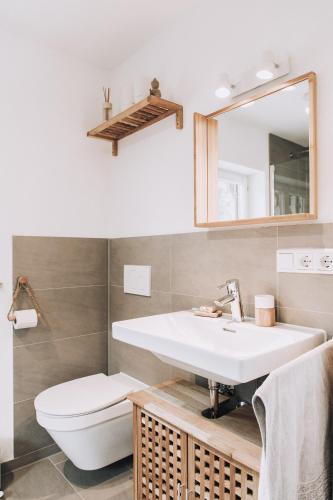 a bathroom with a sink and a toilet at Mountain Mama Ferienhaus in Schliersee