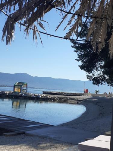 a view of a beach with a building in the background at apartman toni in Trogir