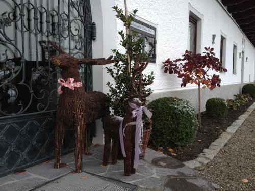 two wooden animals standing outside of a door at Landgasthof Goldener Pflug in Frasdorf