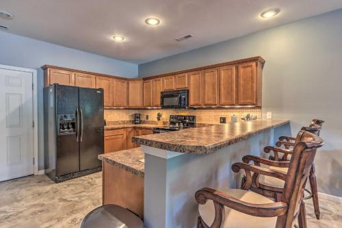 a kitchen with wooden cabinets and stainless steel appliances at Lake View, Pool Access Idyllic Camdenton Condo! in Camdenton