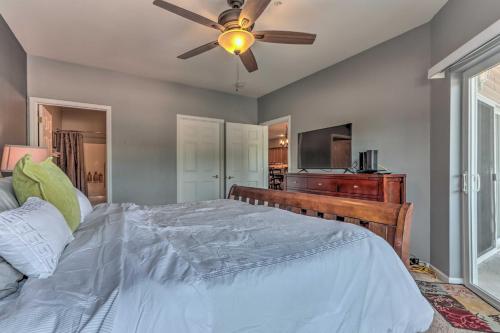 a bedroom with a bed and a ceiling fan at Lake View, Pool Access Idyllic Camdenton Condo! in Camdenton