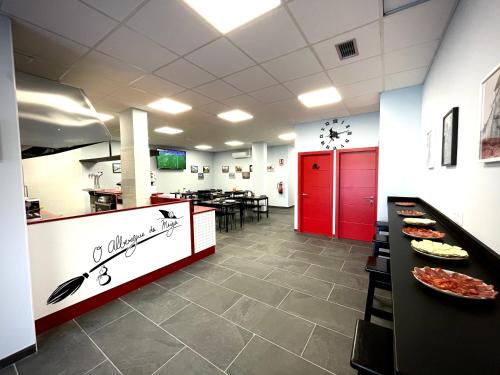 a fast food restaurant with a red and white counter at Hostel & Rooms O Albergue da Meiga in Padrón