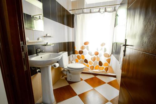 a bathroom with a toilet and a sink at Motel Gzenaya in Tangier