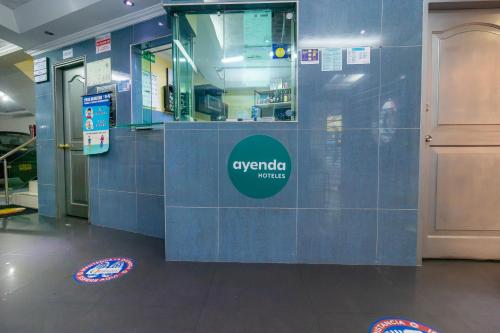 a restaurant with a blue tiled counter in a building at Hotel Ayenda Normandy in Bogotá