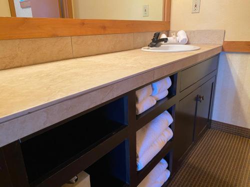 a bathroom with a sink and a counter with towels at Cousin's Country Inn in The Dalles