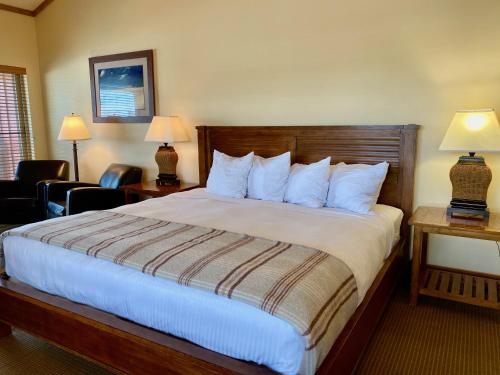a hotel room with a large bed with white pillows at Cousin's Country Inn in The Dalles