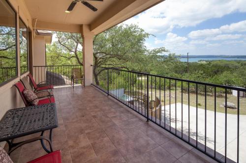 a balcony with a table and chairs and a view of the ocean at Villa at Canyon Lake CL 1233 in Canyon Lake