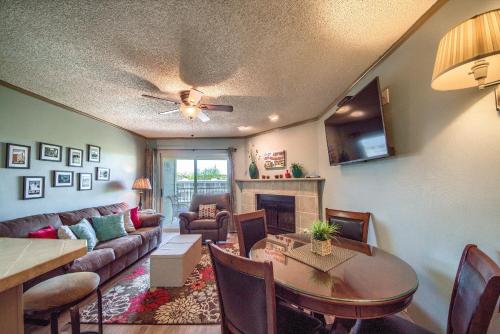 a living room with a couch and a table and a living room with a table at Riverpalooza RRC A305 in New Braunfels
