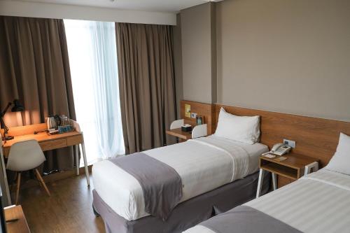 Postel nebo postele na pokoji v ubytování Allstay Hotel Semarang Simpang Lima