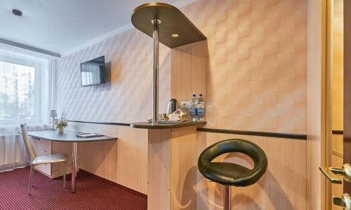 a kitchen with a desk and a chair in a room at Hotel Forum in Magnitogorsk