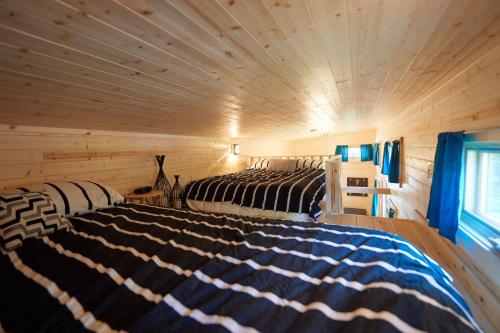 A bed or beds in a room at Tuxbury Pond Camping Resort Tiny House Emerson