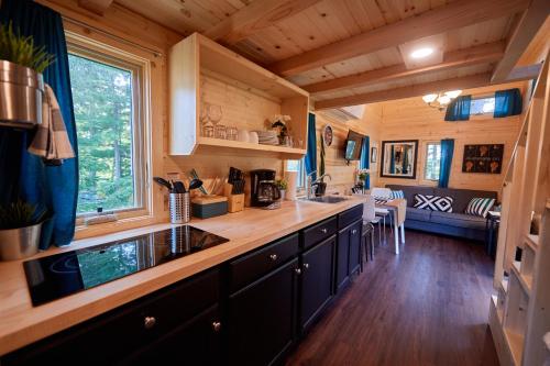 a kitchen with a sink and a counter top at Tuxbury Pond Camping Resort Tiny House Emerson in South Hampton