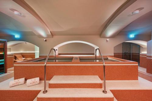 a hot tub in a room with two benches at Áurea Ana Palace by Eurostars Hotel Company in Budapest